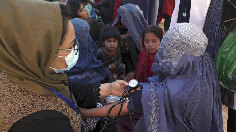 In this Aug. 10, 2021 file photo, an internally displaced woman from northern provinces, who fled her home due to fighting between the Taliban and Afghan security personnel, has her blood pressure taken after taking refuge in a public park in Kabul, Afghanistan. (AP Photo / Rahmat Gul, File)