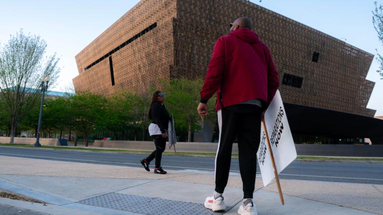 Pastor Robert Turner walks near the National Museum of African American History and Culture as part of his monthly walk from Baltimore to Washington to raise awareness of reparations on Wednesday, April 16, 2025, in Washington. (AP Photo / Nathan Howard)