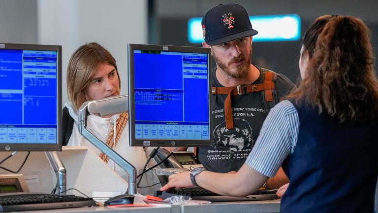 FILE - An airline agent helps travelers in the departures area of Terminal B at LaGuardia Airport, Tuesday, June 27, 2023, in New York. (Mary Altaffer / AP Photo, File)