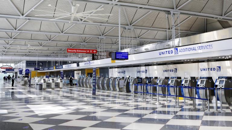 In this June 25, 2020, file photo, rows of United Airlines check-in counters at O'Hare International Airport in Chicago are unoccupied amid the coronavirus pandemic. About 40,000 workers in the airline industry are facing layoffs on Thursday, Oct. 1, unless Congress comes up with another aid package. (AP Photo/Teresa Crawford, File)