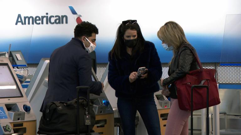 Travelers wear masks at the airport in this file photo. (WTTW News)