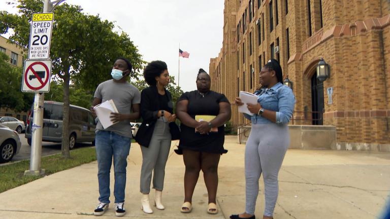 Al Raby High School teacher Jasmine Jones, second from left, and her students talk about their solar panel project. (WTTW News)