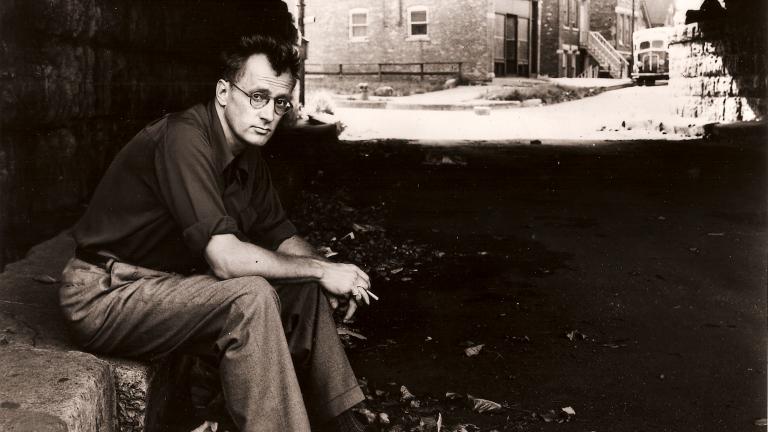 Nelson Algren sitting beneath a viaduct in Chicago. (Library of Congress)