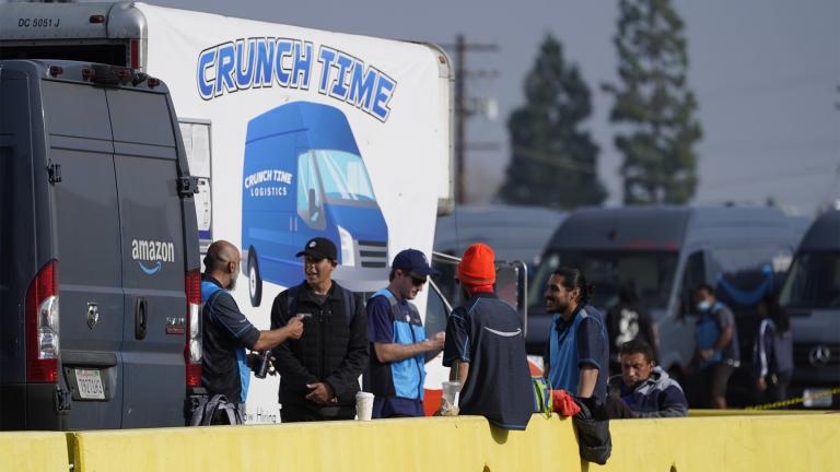 Amazon drivers wait next to a Crunch Time station as their logistics systems is offline at the Amazon Delivery Station in Rosemead, Calif., Tuesday, Dec. 7, 2021.  (AP Photo / Damian Dovarganes)
