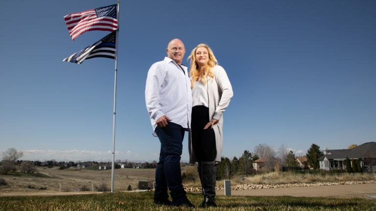 Jennifer and Tim Kohl poses for a photo in their front yard with the American flag and a thin blue line flag in Star, Idaho, on April 14, 2023. The couple recently moved to Idaho from the Los Angeles area. (AP Photo / Kyle Green)