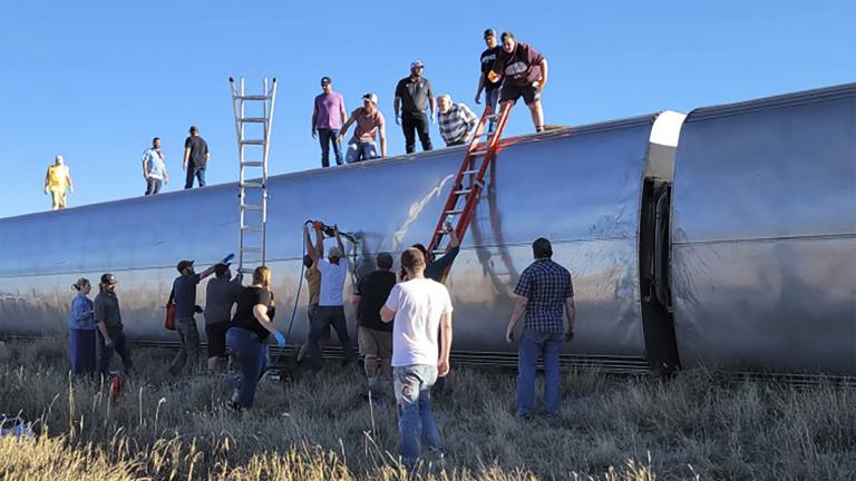 In this photo provided by Kimberly Fossen people work at the scene of an Amtrak train derailment on Saturday, Sept. 25, 2021, in north-central Montana. (Kimberly Fossen via AP)