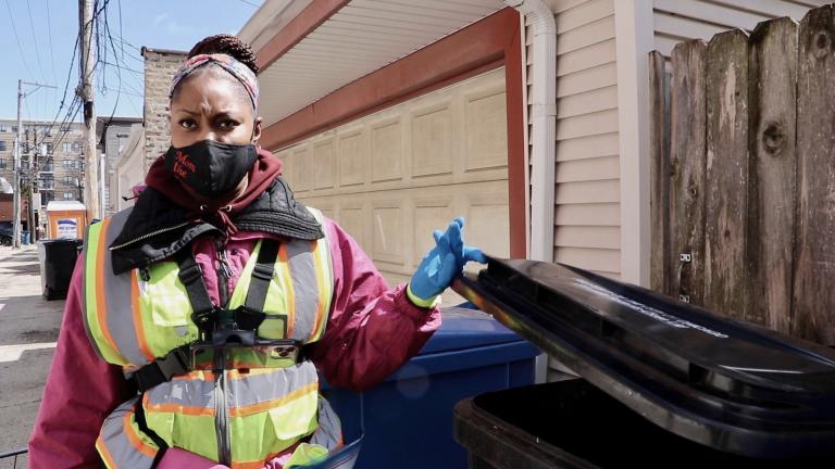 Professional dumpster diver Angel Williams looks through a garbage can in Chicago’s Roscoe Village neighborhood on April 1, 2022. (Evan Garcia / WTTW News)