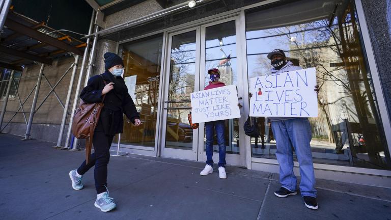 Community activists Calvin, right, and Cameron Hunt show support for the Asian community outside the building where an Asian American woman was assaulted, Tuesday, March 30, 2021, in New York. (AP Photo / Mary Altaffer)