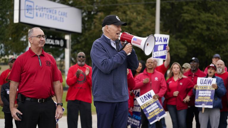 President Joe Biden joins striking United Auto Workers on the picket line, Tuesday, Sept. 26, 2023, in Van Buren Township, Mich. United Auto Workers President Shawn Fain stands at left. (AP Photo/Evan Vucci)