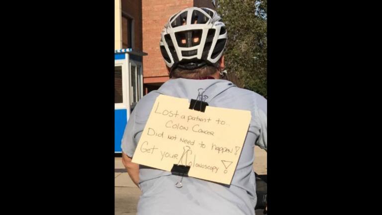 Advocate Illinois Masonic Medical Center gastroenterologist Dr. Andrew Albert rides home wearing a sign urging people to be screened for colon cancer after one of his patients died and another who had never had a colonoscopy was found to have a tumor. (Courtesy of Dr. Andrew Albert)