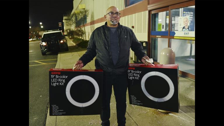 Daniel Ramon, 55, of Livonia, talks about his purchase of led lights for his daughters outside the Best Buy store in Novi, Mich., on Friday, Nov. 26, 2021. (Clarence Tabb, Jr. / Detroit News via AP)