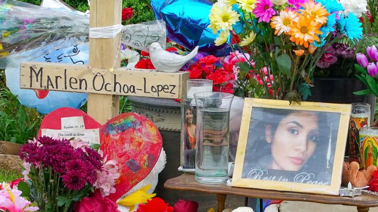 FILE - A memorial of flowers, balloons, a cross and photo of victim Marlen Ochoa-Lopez, are displayed on a lawn, May 17, 2019, in Chicago, outside the home where Ochoa-Lopez was murdered. (Teresa Crawford / AP Photo, File)