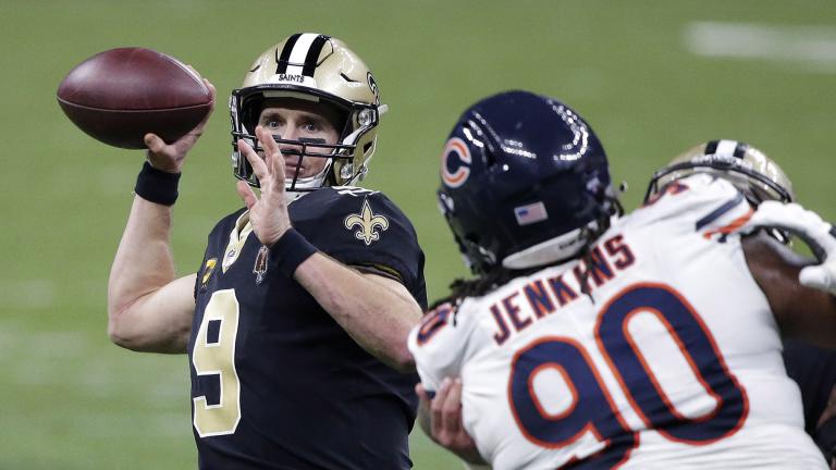 New Orleans Saints quarterback Drew Brees (9) passes under pressure from Chicago Bears defensive tackle John Jenkins (90) in the second half of an NFL wild-card playoff football game in New Orleans, Sunday, Jan. 10, 2021. (AP Photo / Butch Dill)