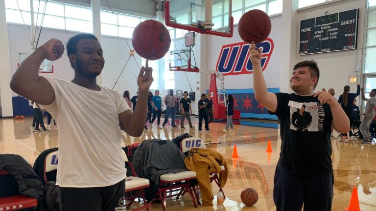 Courtney Thomas, left, and Salvador Ramirez, right, practice their basketball skills at the UIC Flames Athletic Center on Oct. 16, 2025. (Eunice Alpasan / WTTW News)