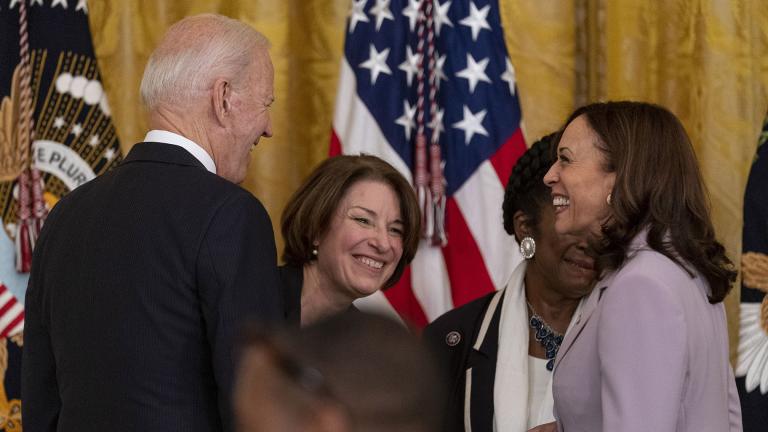 President Joe Biden, Sen. Amy Klobuchar, D-Minn., center, and Vice President Kamala Harris, right, share a laugh after the president signed H.R. 1652, the VOCA Fix to Sustain the Crime Victims Fund Act of 2021, in the East Room of the White House in Washington, Thursday, July 22, 2021. (AP Photo / Andrew Harnik)