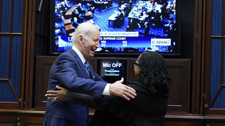 President Joe Biden goes to hug Supreme Court nominee Judge Ketanji Brown Jackson as they watch the Senate vote on her confirmation from the Roosevelt Room of the White House in Washington, Thursday, April 7, 2022. (AP Photo / Susan Walsh)