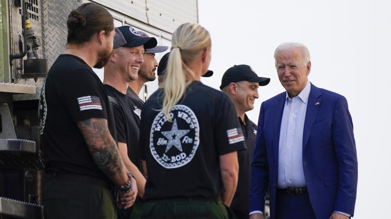 President Joe Biden greets firefighters as he tours the National Interagency Fire Center, Sept. 13, 2021, in Boise, Idaho. (AP Photo / Evan Vucci, File)