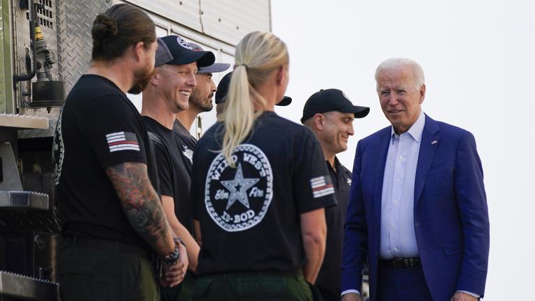 President Joe Biden greets firefighters as he tours the National Interagency Fire Center, Sept. 13, 2021, in Boise, Idaho. (AP Photo / Evan Vucci, File)