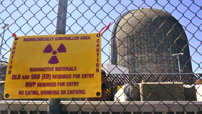 A sign warning of radioactive materials is seen on a fence around a nuclear reactor containment building on Monday, April 26, 2021, a few days before it stopped generating electricity at Indian Point Energy Center in Buchanan, N.Y. (AP Photo / Seth Wenig, File)