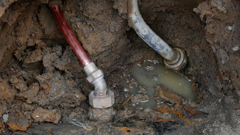 FILE - A copper water supply line, left, is shown connected to a water main after being installed for lead pipe, right, July 20, 2018, in Flint, Mich. (Paul Sancya / AP Photo, File)