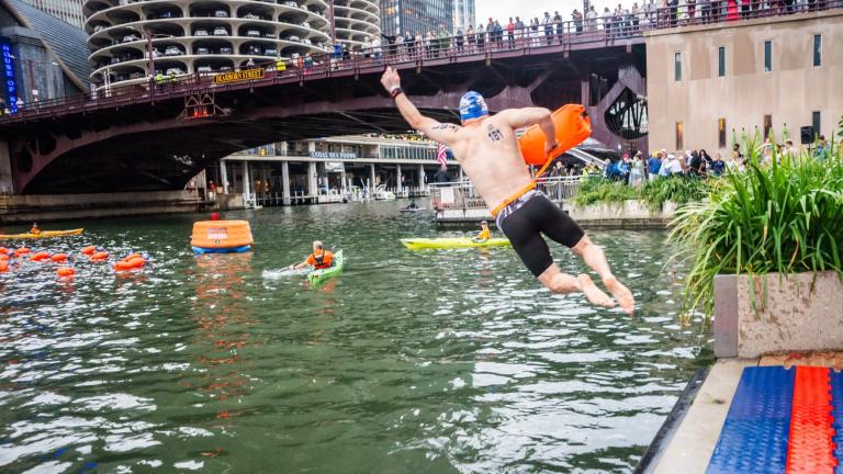 A participant enters the water during the 2025 Chicago River Swim. The Big Jump has been added to the 2026 event for folks prepared to take the plunge but not go the distance. (Linda Barrett / Chicago River Swim)