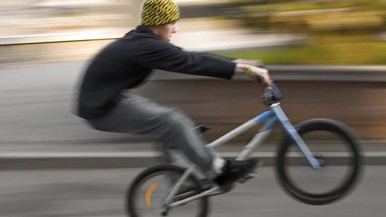 A BMX biker performing a wheelie. (Andrey Marshak / Wikimedia Commons)