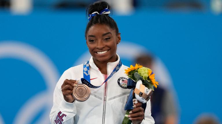 FILE - U.S. gymnast Simone Biles poses with her bronze medal for the artistic gymnastics women's balance beam apparatus at the 2020 Summer Olympics, Tuesday, Aug. 3, 2021, in Tokyo, Japan. (AP Photo / Jae C. Hong, File)