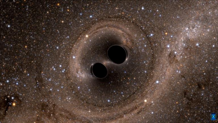 The collision of two black holes—an event detected for the first time ever by the Laser Interferometer Gravitational-Wave Observatory, or LIGO—is seen in this still from a computer simulation. (Credit: SXS)