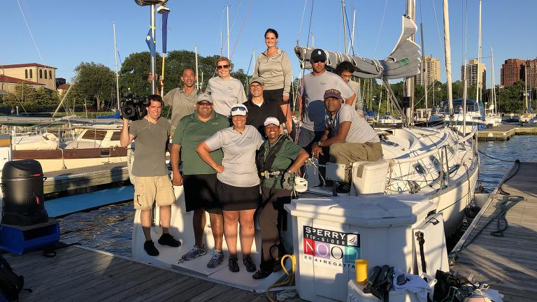 Producer Jay Shefsky and cameraman Felix Mendez pose with the crew of Mise en Place at Jackson Park Harbor. 