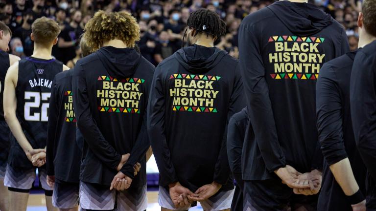 FILE - Washington players stand during the playing of the national anthem wearing warm-up jackets for Black History Month before an NCAA college basketball game against Arizona, Feb. 12, 2022, in Seattle. (John Froschauer / AP Photo, File)