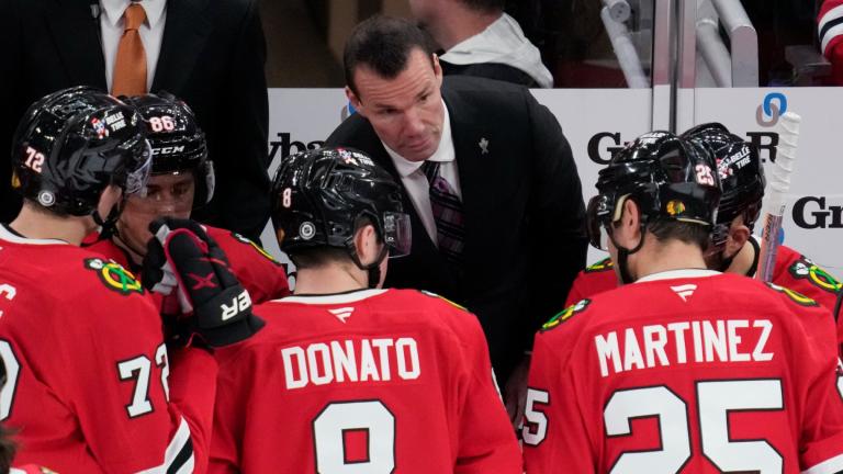 Chicago Blackhawks head coach Luke Richardson, center top, talks to his players during the third period of an NHL hockey game against the Columbus Blue Jackets in Chicago, Sunday, Dec.1, 2024. (AP Photo / Nam Y. Huh)