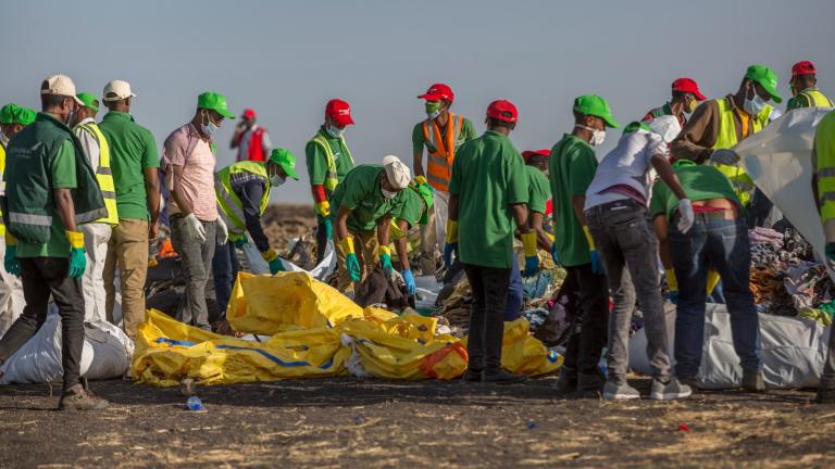 Workers collect debris on March 12, 2019 at the scene where an Ethiopian Airlines Boeing 737 Max 8 crashed shortly after takeoff, killing all 157 on board, near Bishoftu, or Debre Zeit, south of Addis Ababa, in Ethiopia. (AP Photo / Mulugeta Ayene, File)