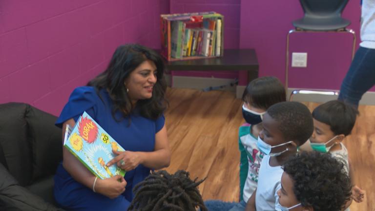 Seena Jacob, founder of nonprofit BookWallah, reads to a group of children at a Boys and Girls Club in the North Center neighborhood. (WTTW News.)