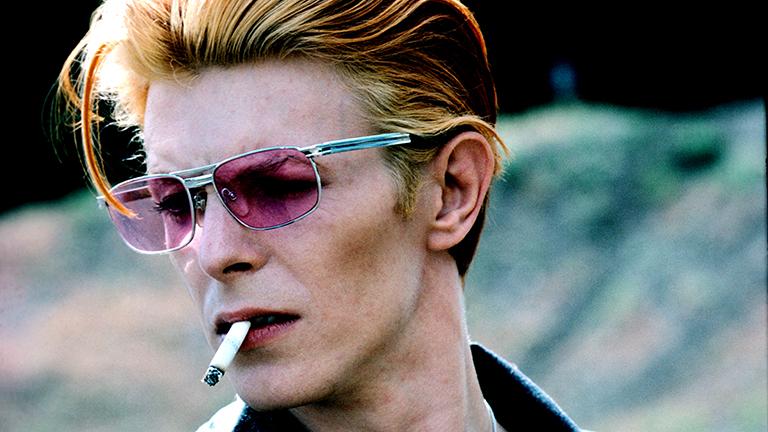 David with cigarette on a break from filming “The Man Who Fell to Earth” in New Mexico 1975. This became a Rolling Stone cover and a popular image. (Steve Schapiro / powerHouse Books)