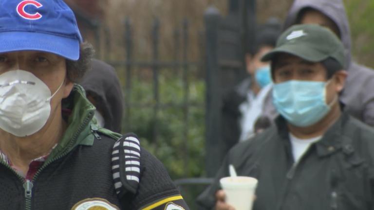 People wait in line for a food drive in Brighton Park on Chicago’s Southwest Side on April 23, 2020. (WTTW News)