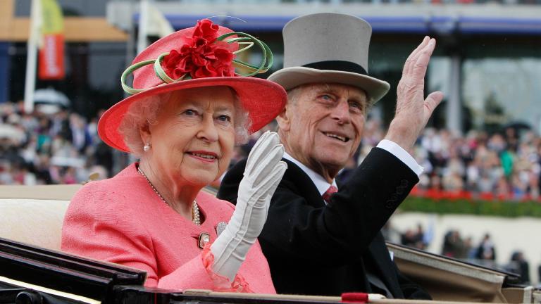 In this Thursday June, 16, 2011 file photo Britain’s Queen Elizabeth II with Prince Philip arrive by horse drawn carriage in the parade ring on the third day, traditionally known as Ladies Day, of the Royal Ascot horse race meeting at Ascot, England. (AP Photo/Alastair Grant, File)