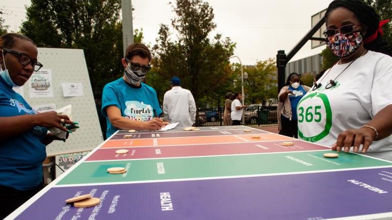 Community members participate in a budget game outlining their priorities Saturday, Sept. 26, 2020 in Austin’s Moore Park. (Grace Del Vecchio / WTTW News)