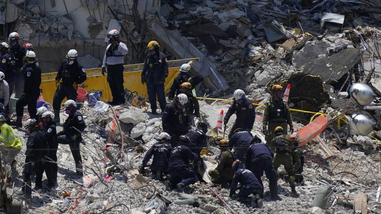 Search and rescue personnel work atop the rubble at the Champlain Towers South condo building, where scores of victims remain missing more than a week after it partially collapsed, Friday, July 2, 2021, in Surfside, Fla. (AP Photo / Mark Humphrey)