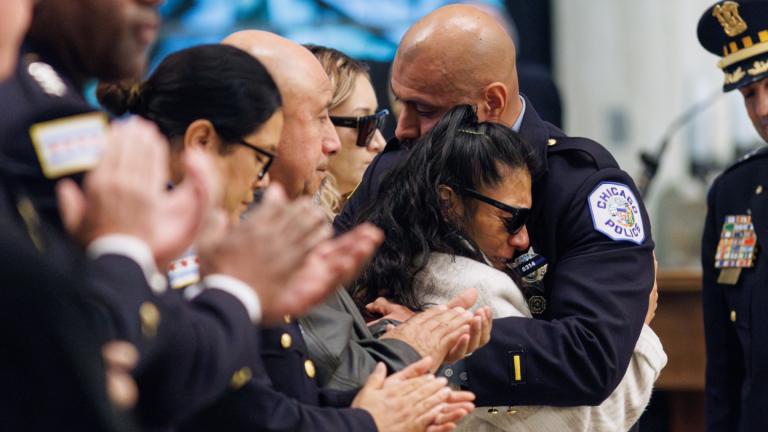 Adrian Martinez Jr. hugs his mother, Rosa Mayen, after speaking at the funeral for Officer Enrique Martinez at St. Rita Cascia Shrine, 7740 S. Western Ave., on Nov. 18, 2024. (Anthony Vazquez / Sun-Times via Pool)