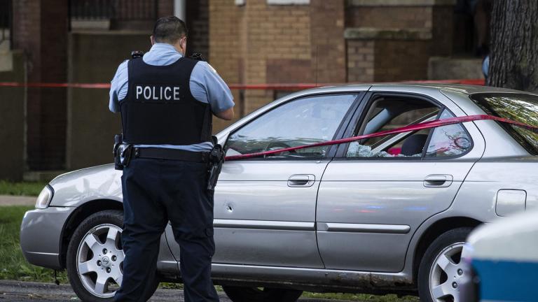 A Chicago police officer investigates the scene of a shooting in Chicago on Sunday, July 5, 2020. (Ashlee Rezin Garcia / Chicago Sun-Times via AP)