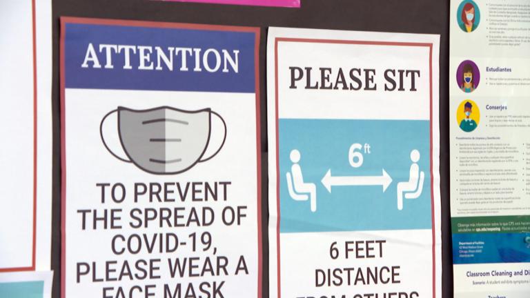 In this file photo, COVID-19 health and safety signs are posted. (WTTW News)