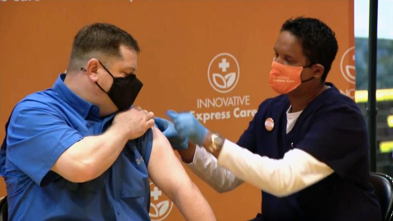Jeff Lorenz, a teacher at Roosevelt High School, receives a COVID-19 vaccination at his school on March 17, 2021. (WTTW News)
