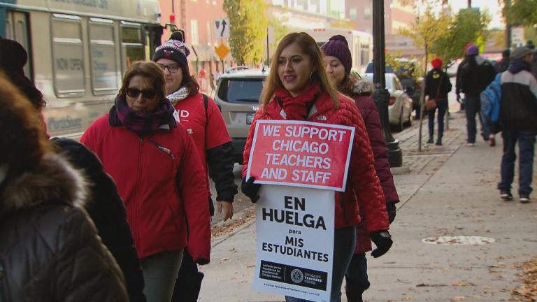 Striking Chicago Public Schools teachers carry signs on Monday, Oct. 28, 2019, day eight of the Chicago teachers strike. (WTTW News)