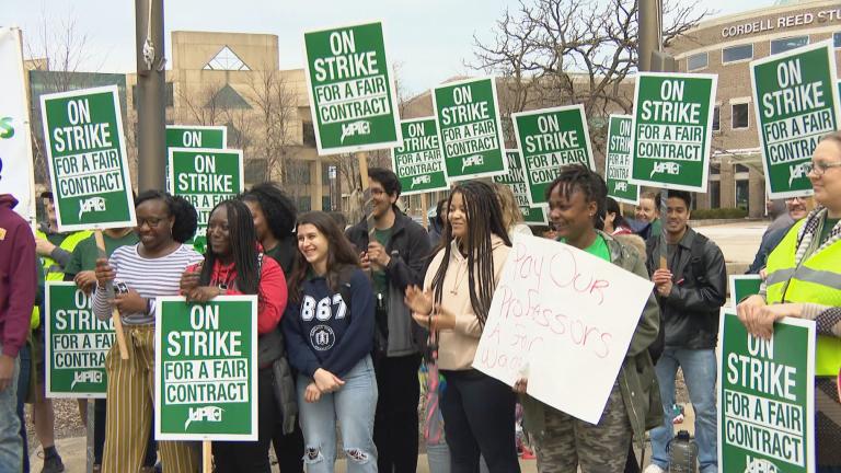 Striking Chicago State University faculty members hold signs outside the school on April 10, 2023. (WTTW News)