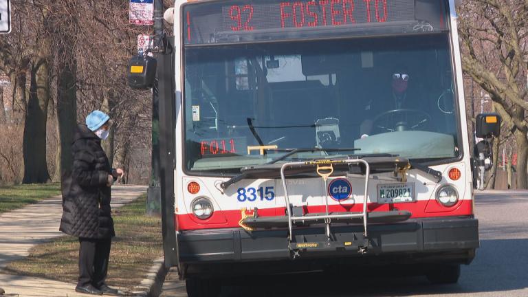 A person wearing a face mask boards a CTA Foster bus on Thursday, April 2, 2020. (WTTW News)