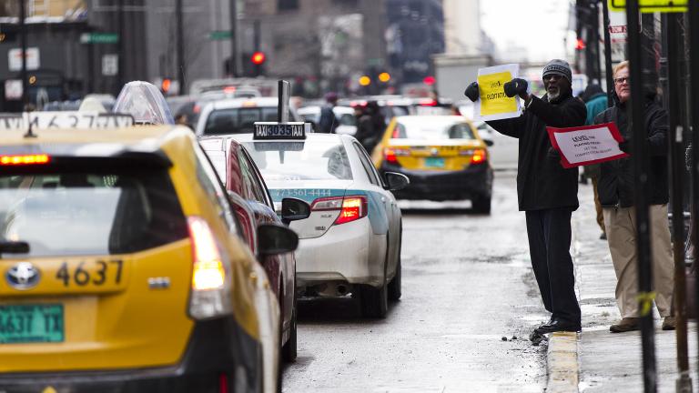 Chicago taxi drivers protest ride-sharing services like Uber and Lyft by holding signs and driving around City Hall in February 2015. (ScottMLiebenson / Wikimedia Commons)