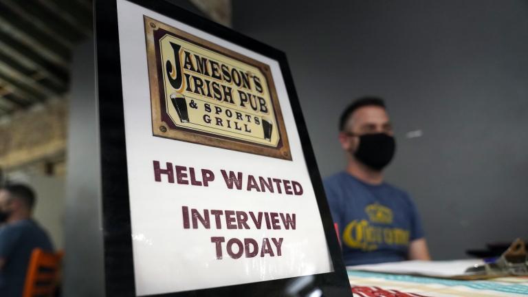 A hiring sign is shown at a booth for Jameson's Irish Pub during a job fair on Sept. 22, 2021, in the West Hollywood section of Los Angeles. (AP Photo/Marcio Jose Sanchez, File)