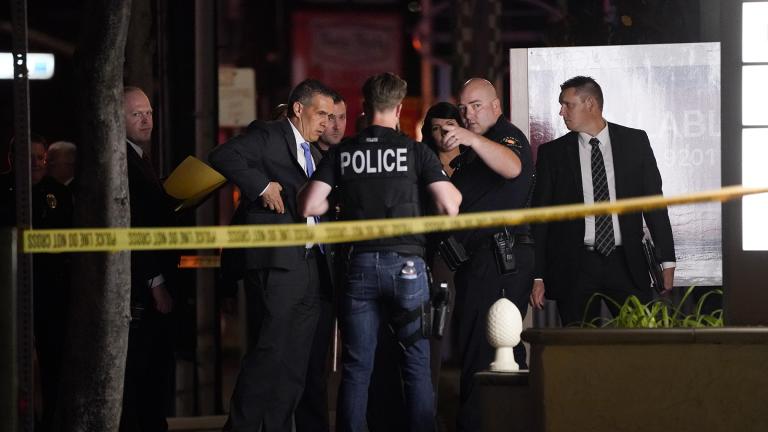 Investigators gather outside an office building where a shooting occurred in Orange, Calif., Wednesday, March 31, 2021. (AP Photo / Jae C. Hong)