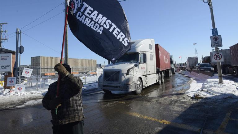 A Canadian Pacific Railway worker walks the picket line while on strike at the Cote Saint-Luc railyard in Montreal on Feb. 16, 2015.  (Ryan Remiorz / The Canadian Press via AP)