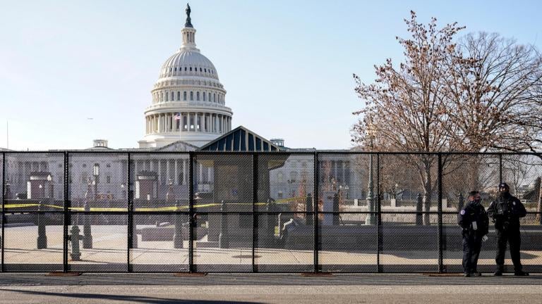 Capitol police officers stand outside of fencing that was installed around the exterior of the Capitol grounds, Thursday, Jan. 7, 2021 in Washington. (AP Photo / John Minchillo)